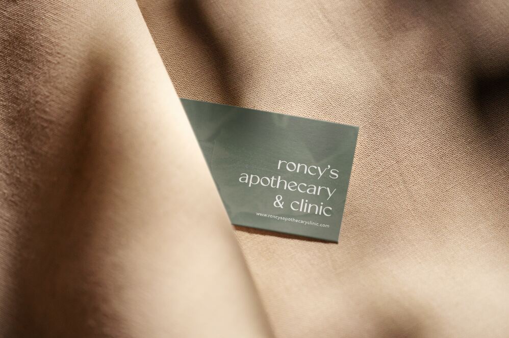 roncys apothecary and clinic business card mockup hidden in linen dark beige fabric